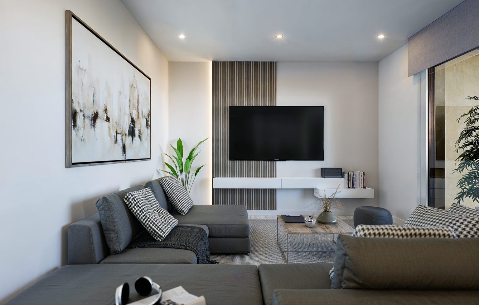 Salón de vivienda con zona de estar y mueble de televisión